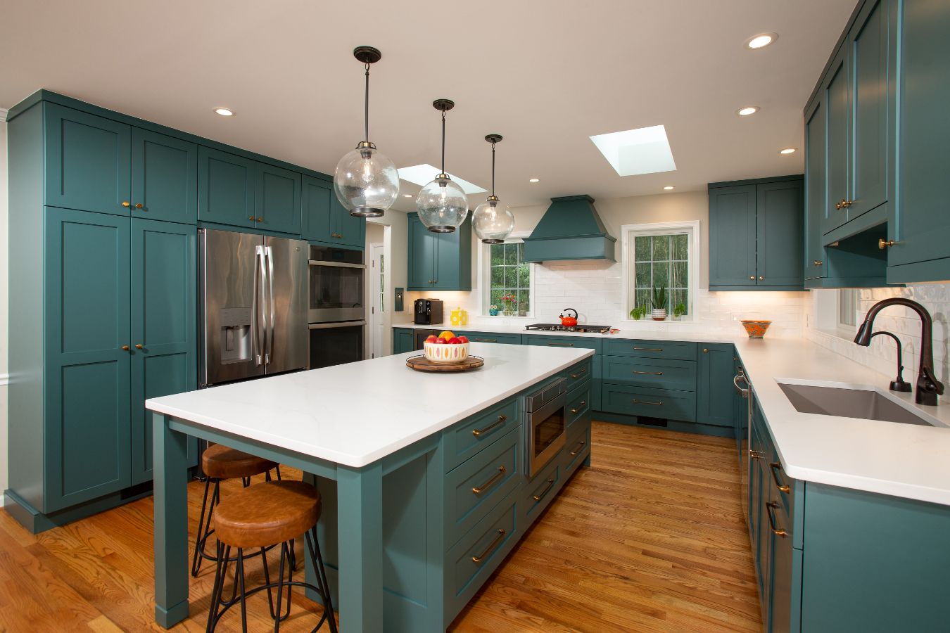White Kitchen Countertops on Teal Cabinets with Brass and Black Hardware Accents - Rust Construction | Northern Virginia Kitchen Remodels
