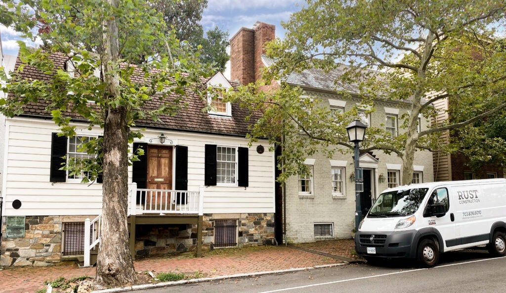 Historic house on the site of George Washington’s Town House in Old Town Alexandria, with wood siding, brick foundation, and early residential scale