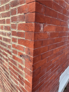 Nice bricks on front face Corner of historic brick wall in Alexandria showing contrast between original lime mortar joints and newer repointed sections