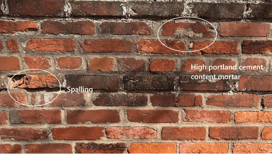 Historic brick wall in Alexandria showing spalling and damage caused by high cement-content mortar