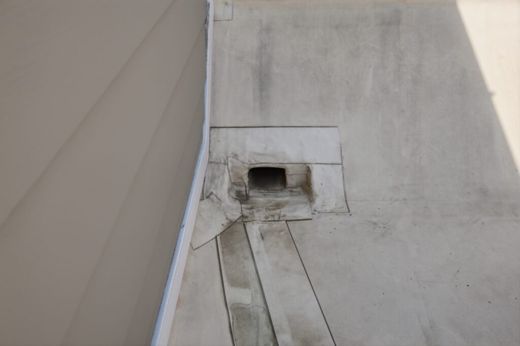 A properly flashed scupper on a flat roof: the first stop for rainwater before it ever reaches a downspout.